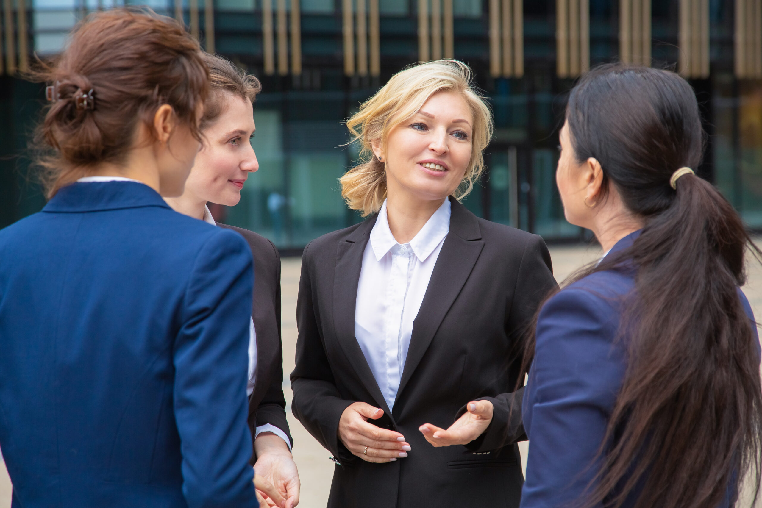 Female business colleagues discussing project outdoors